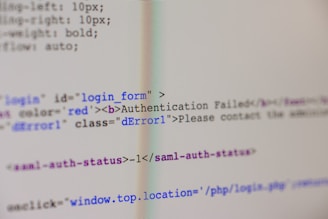 A close-up view of HTML code on a computer screen includes a login form with an error message indicating 'Authentication Failed'. The text has some parts styled in red, signifying an error or warning message.