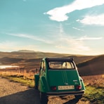 green volkswagen t-1 on dirt road during daytime