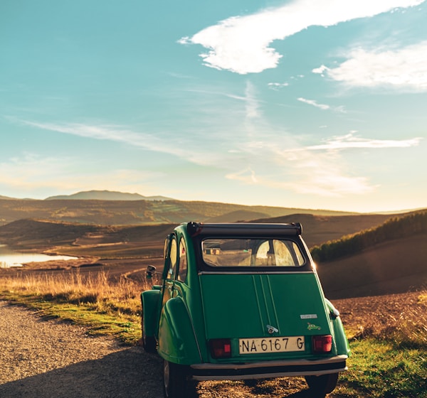 green volkswagen t-1 on dirt road during daytime