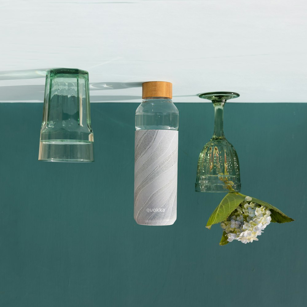 Botella de vidrio transparente con tapa de madera marrón