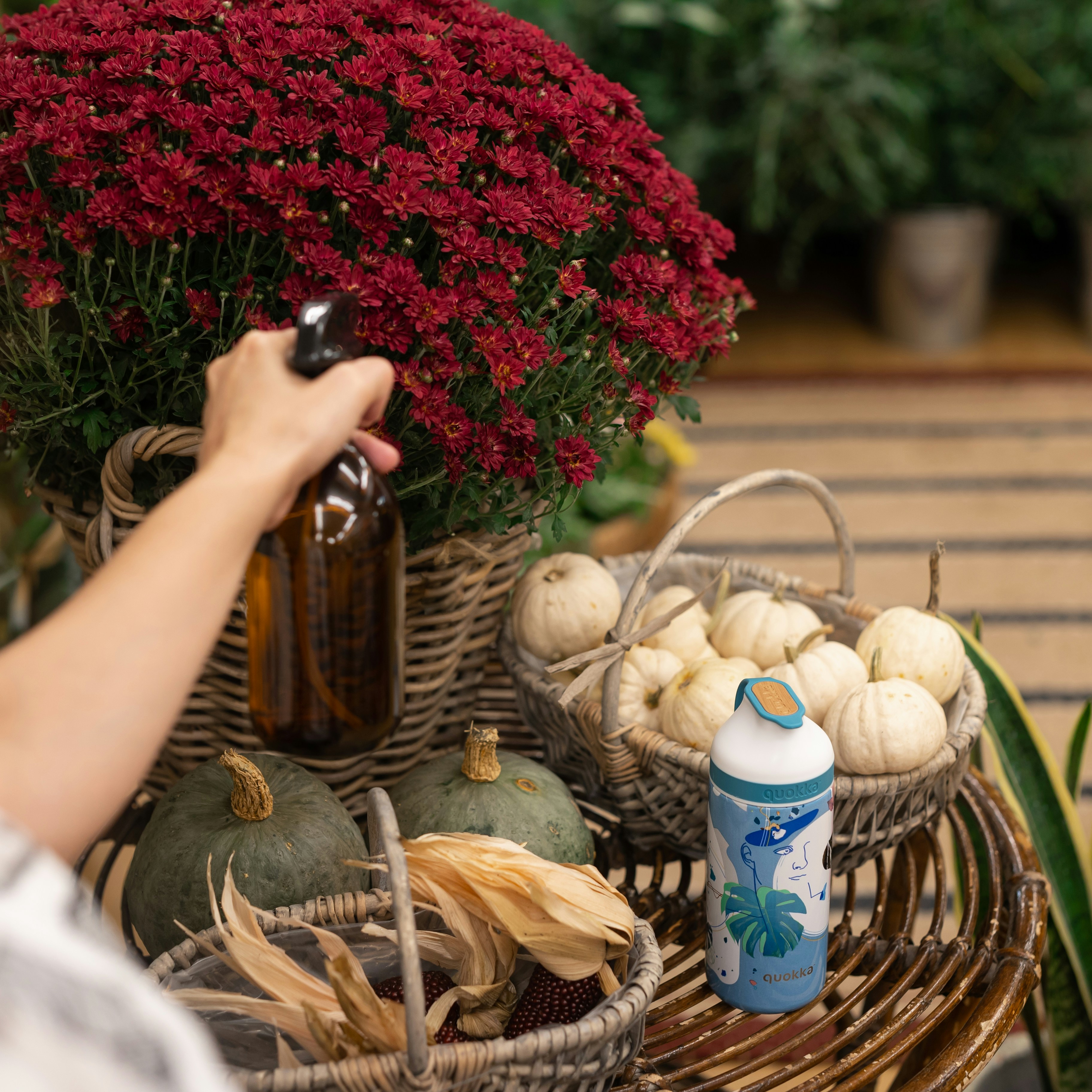 person pouring water on brown woven basket