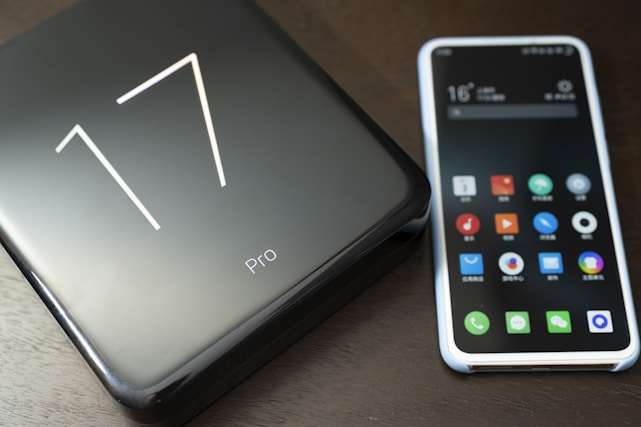 A sleek smartphone displaying the Carrom Pro Max game interface with vibrant blue and white colors.