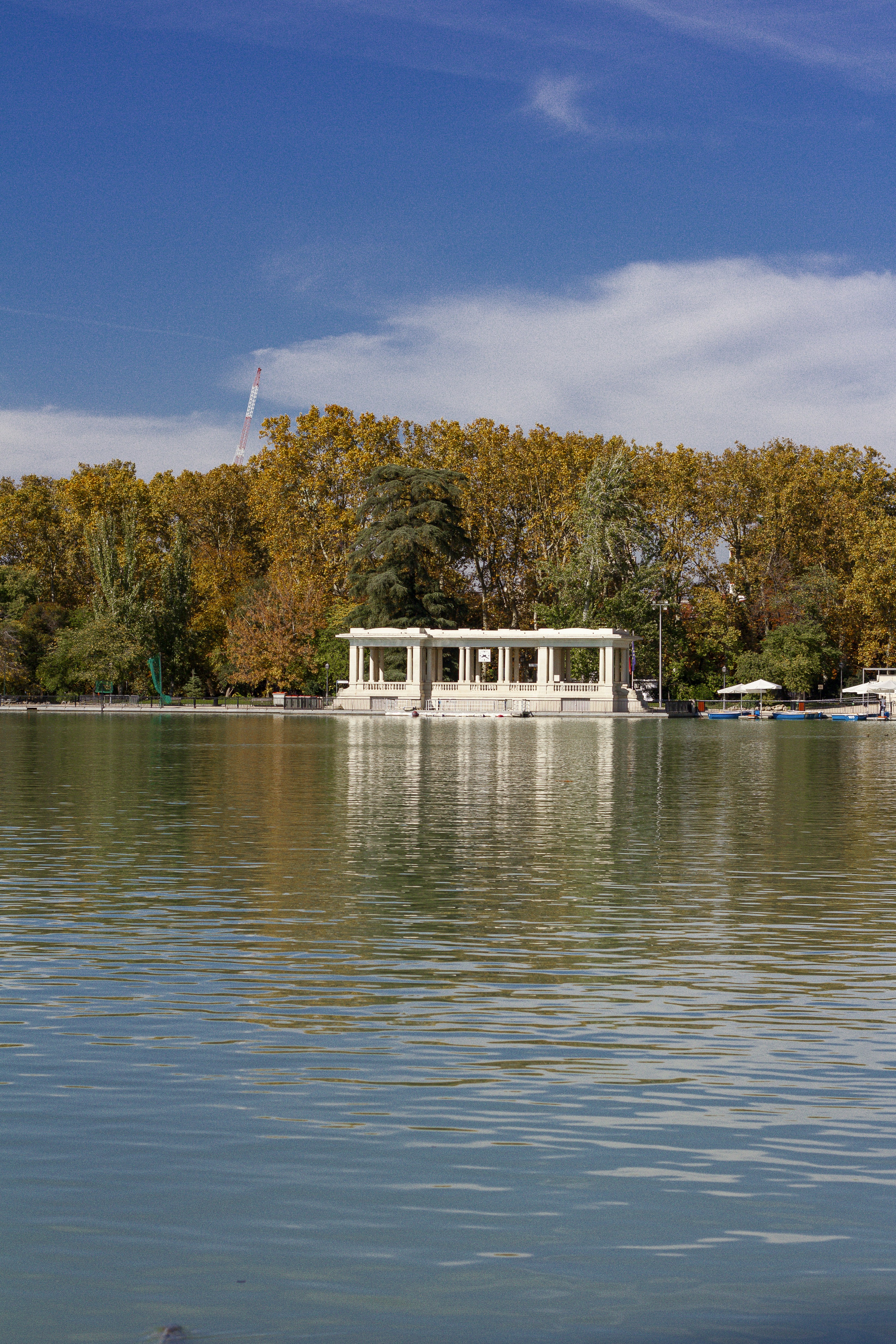 white and brown house near body of water during daytime