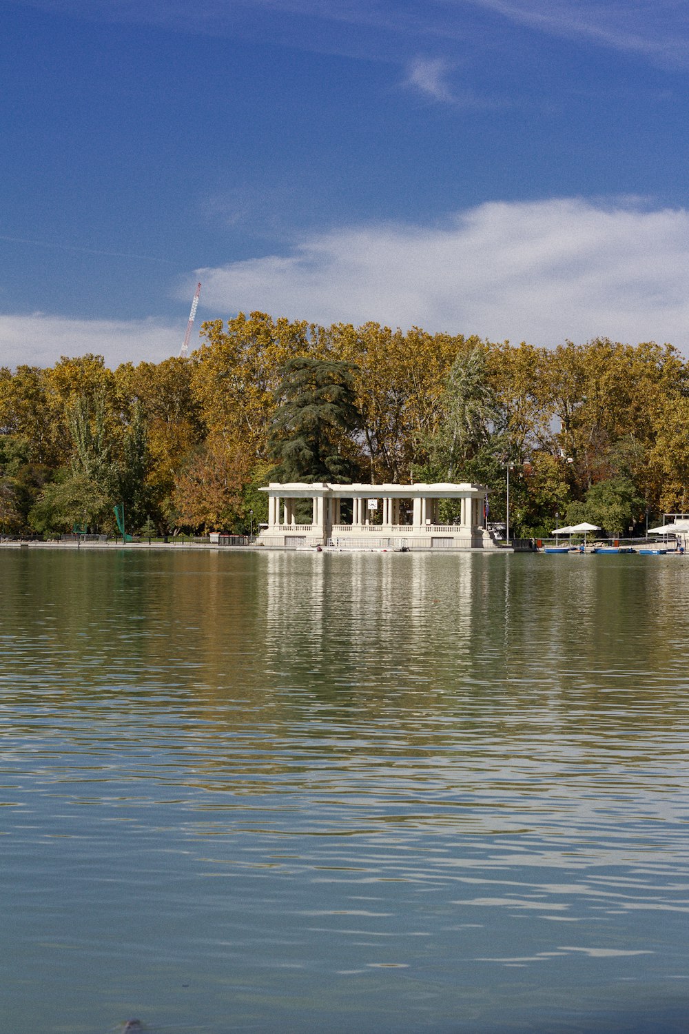 white and brown house near body of water during daytime