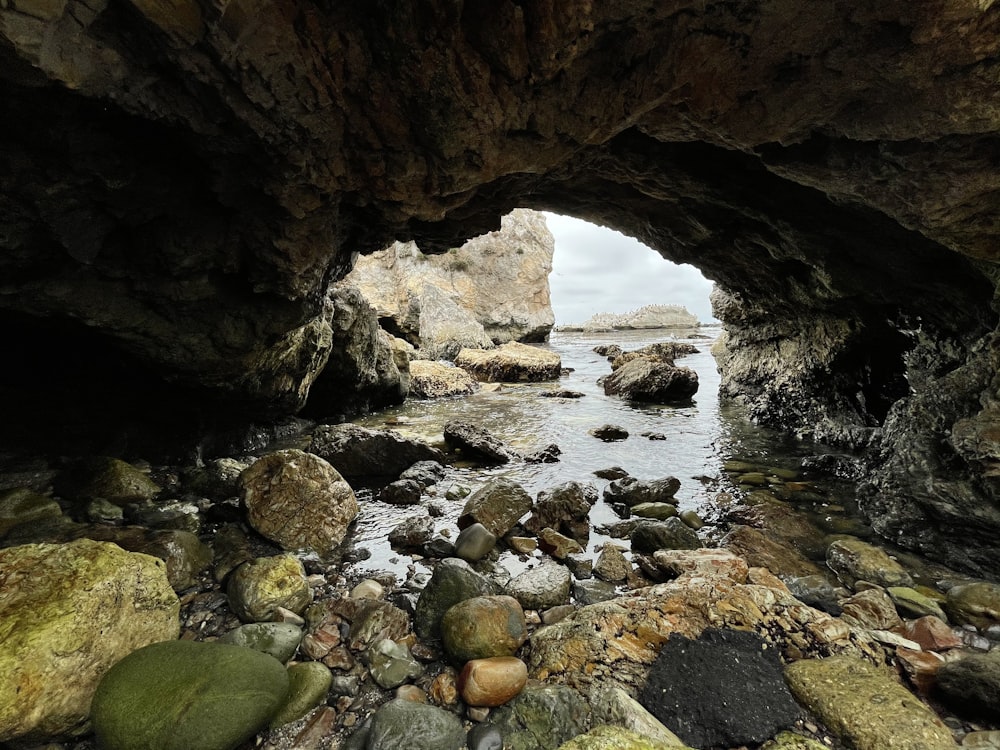 brown rock formation on body of water during daytime