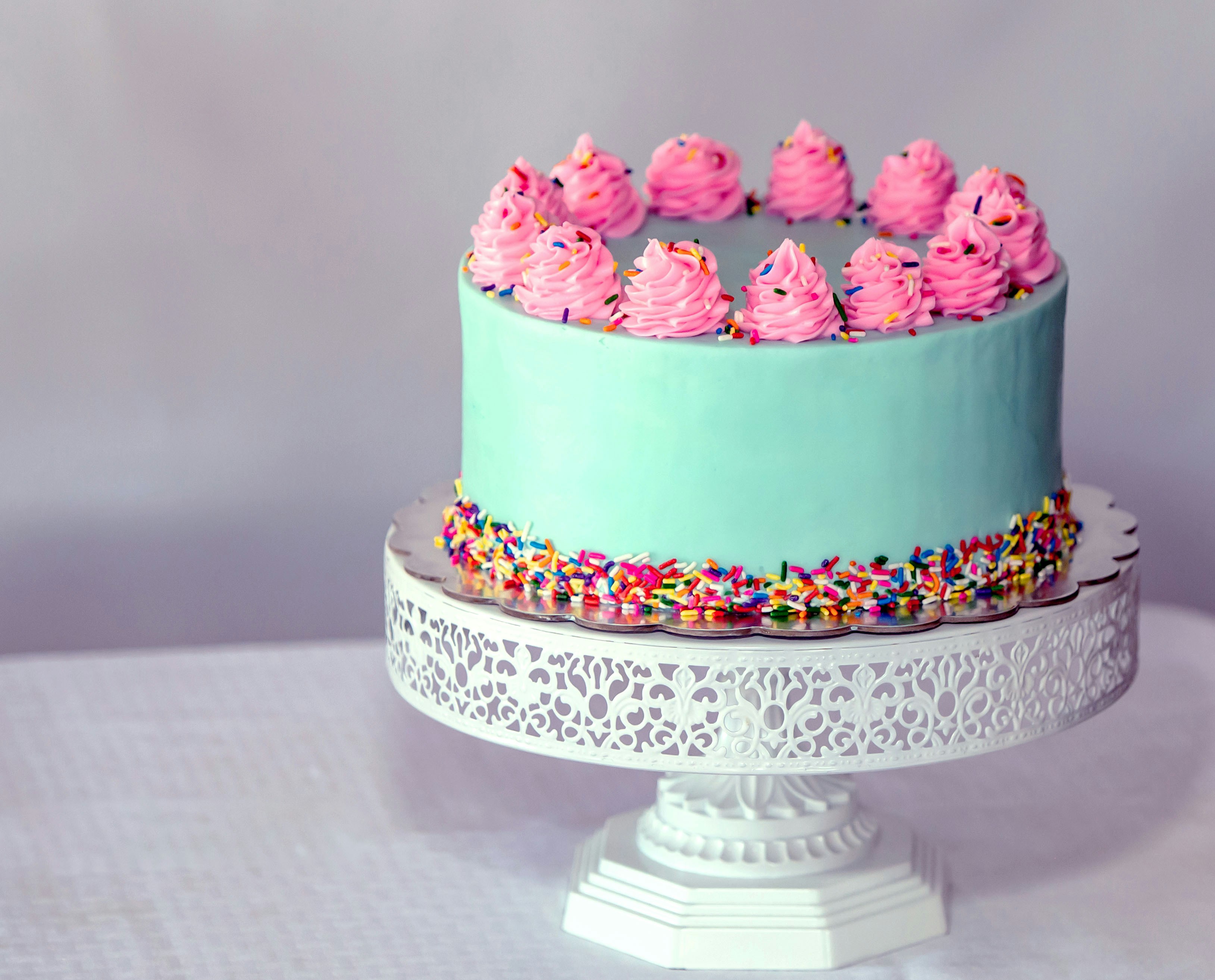 A cheerful birthday cake, bursting with excitement and joy.