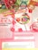 A colorful assortment of candies, including a large rainbow lollipop, Sassy Tarts, Smarties, and Starburst, is displayed on top of a magazine page discussing sugar addiction. Pink, green, and blue plastic spiral toys are placed around the candies. The page contains information about sugar consumption, a quiz on sugar addiction, and a recipe for crack pie.