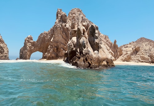 brown rock formation on sea during daytime