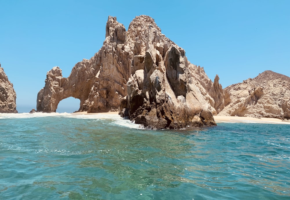 brown rock formation on sea during daytime