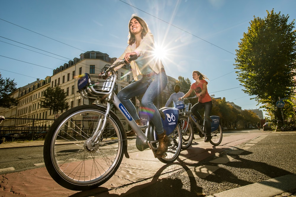 2 women riding on bicycles during daytime