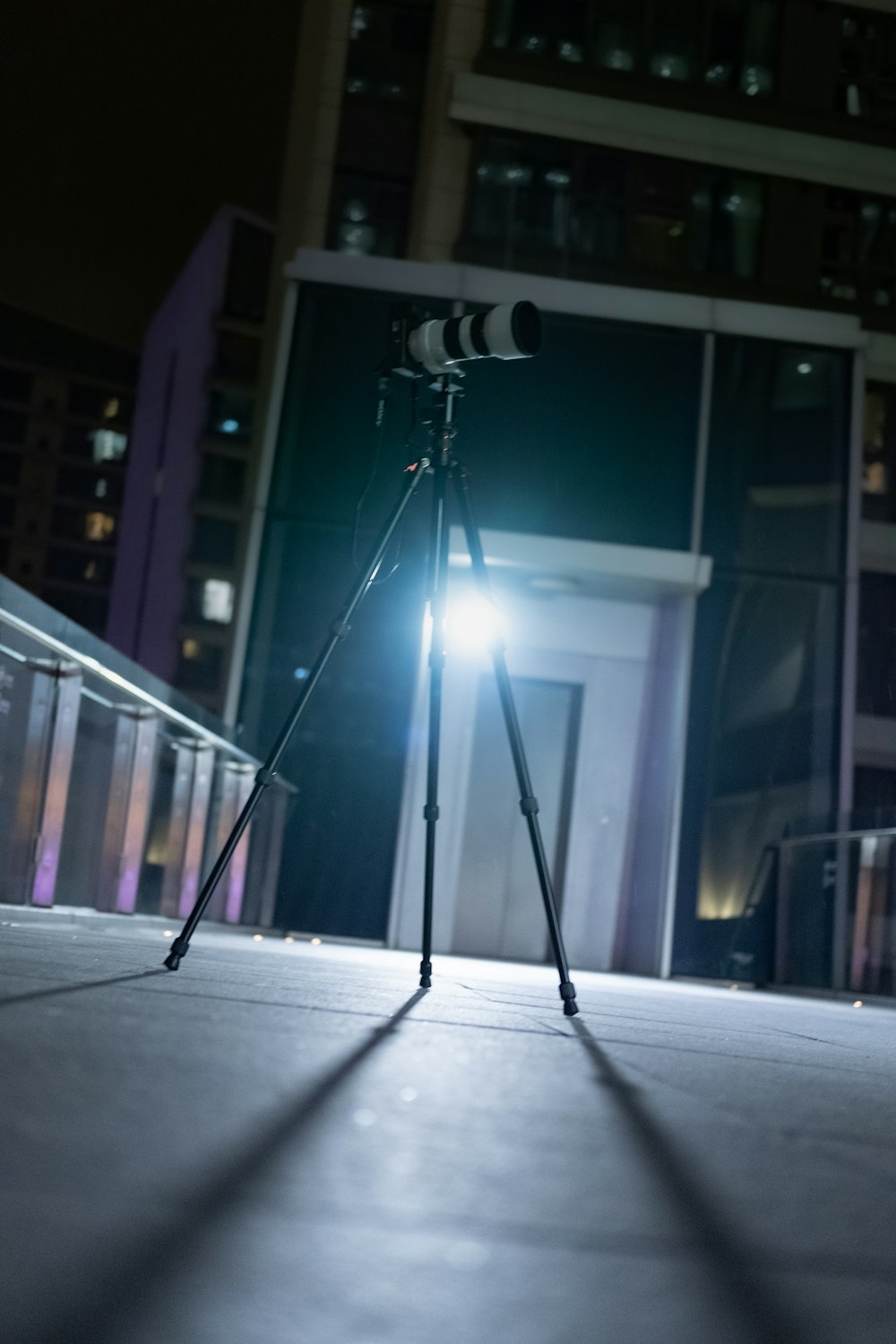 black and gray tripod stand on gray concrete floor