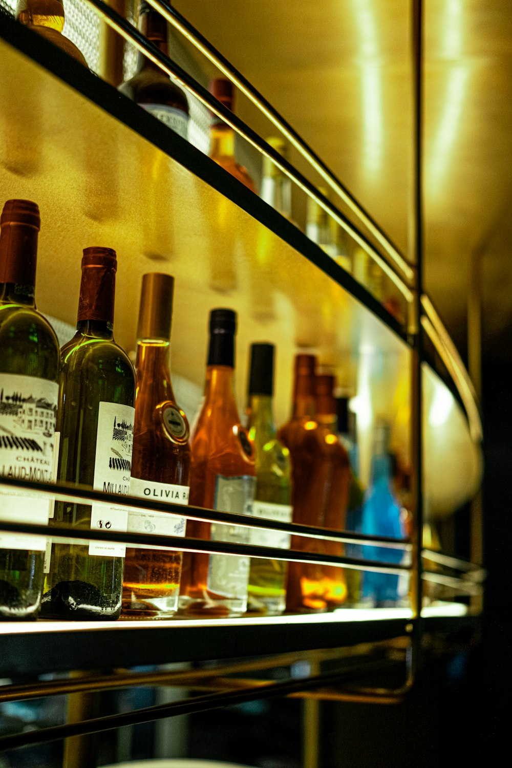 glass bottles on glass shelf