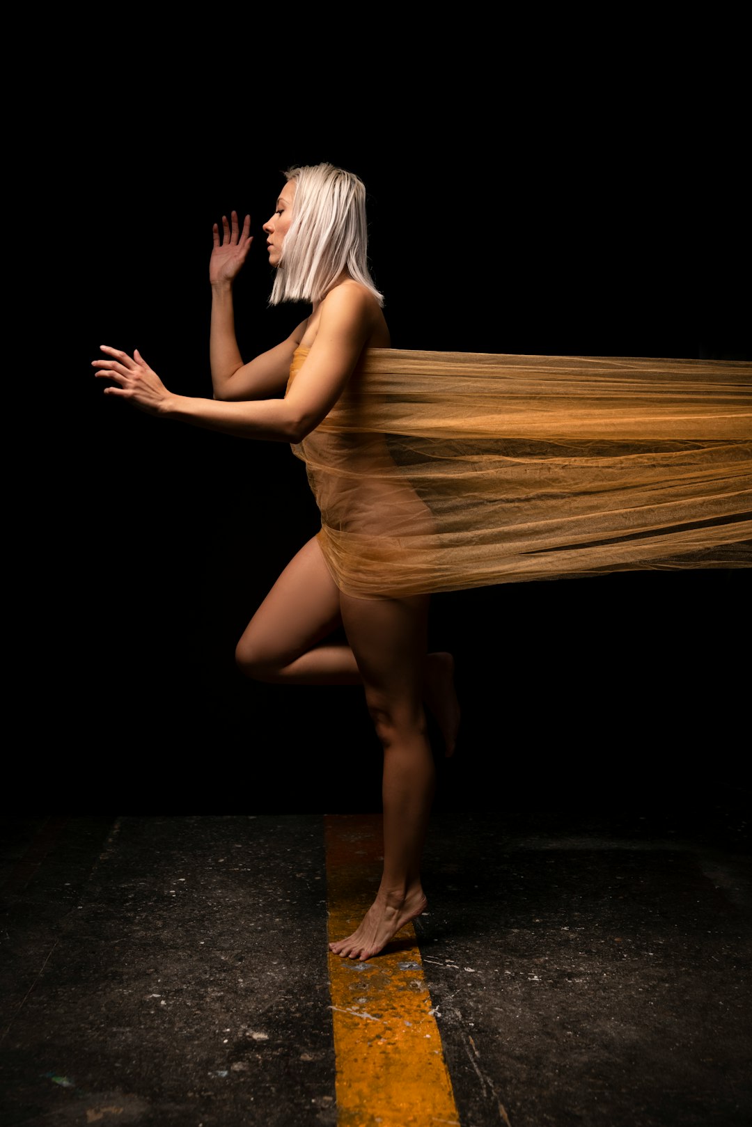 woman in white dress standing on black floor