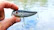 Close-up of a sleek midnight ripper lure glistening with water droplets against a dark, textured background.
