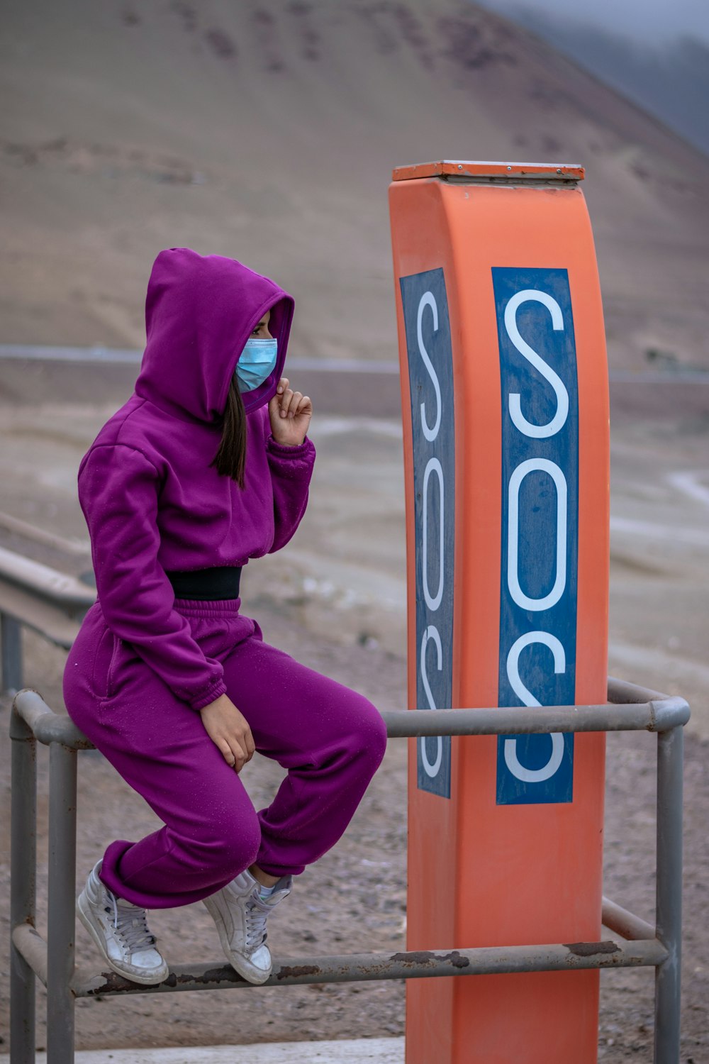 person in purple hoodie and purple pants wearing black sunglasses