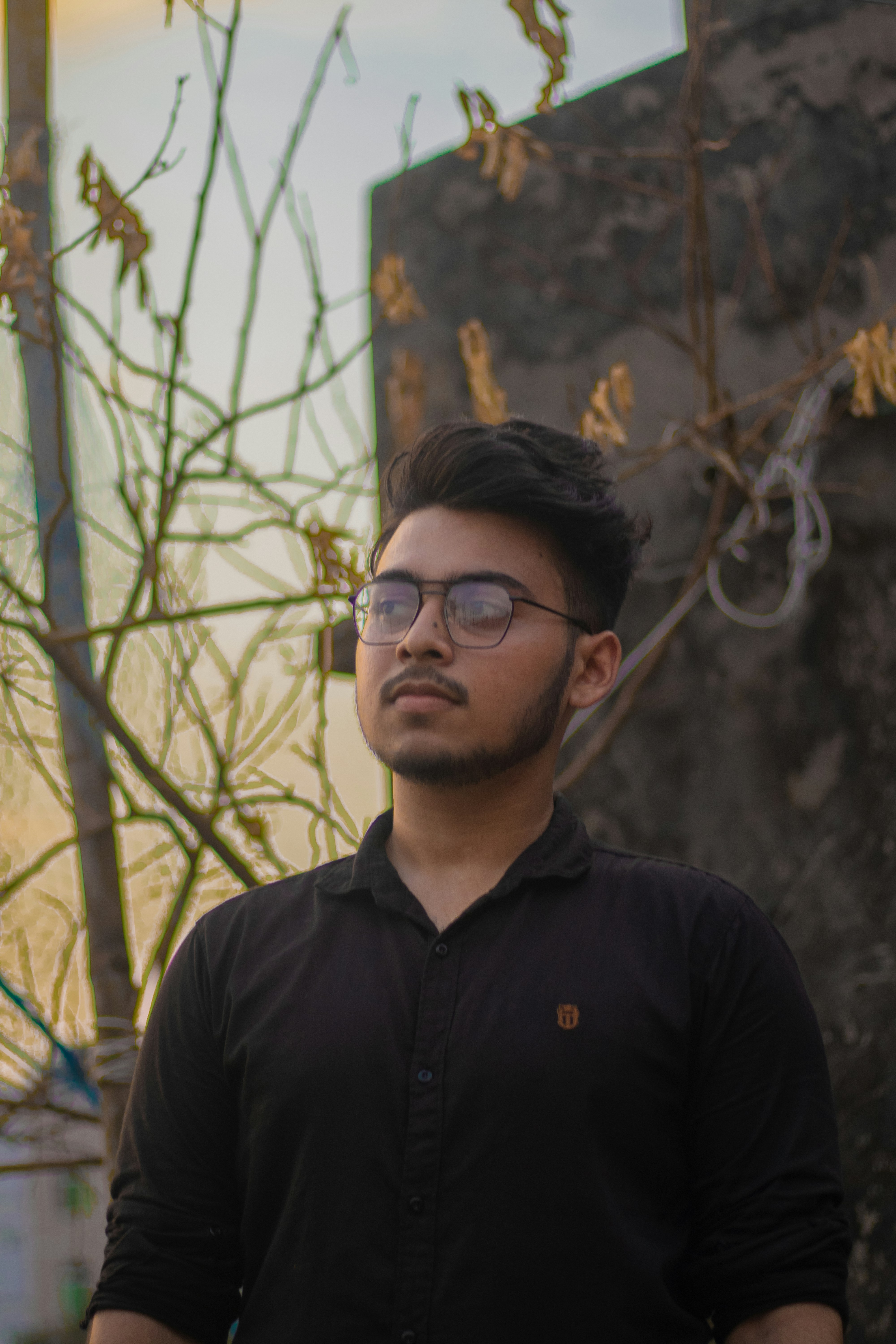 man in black polo shirt wearing black framed eyeglasses