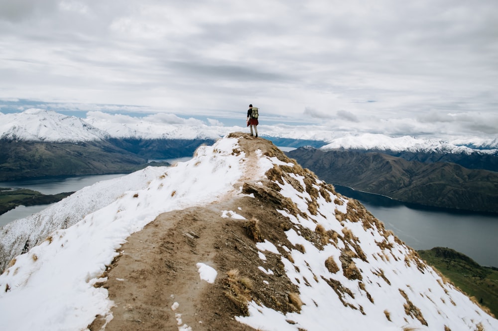 person standing on white snow covered mountain during daytime