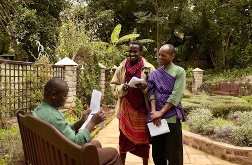 man in purple dress shirt holding white paper