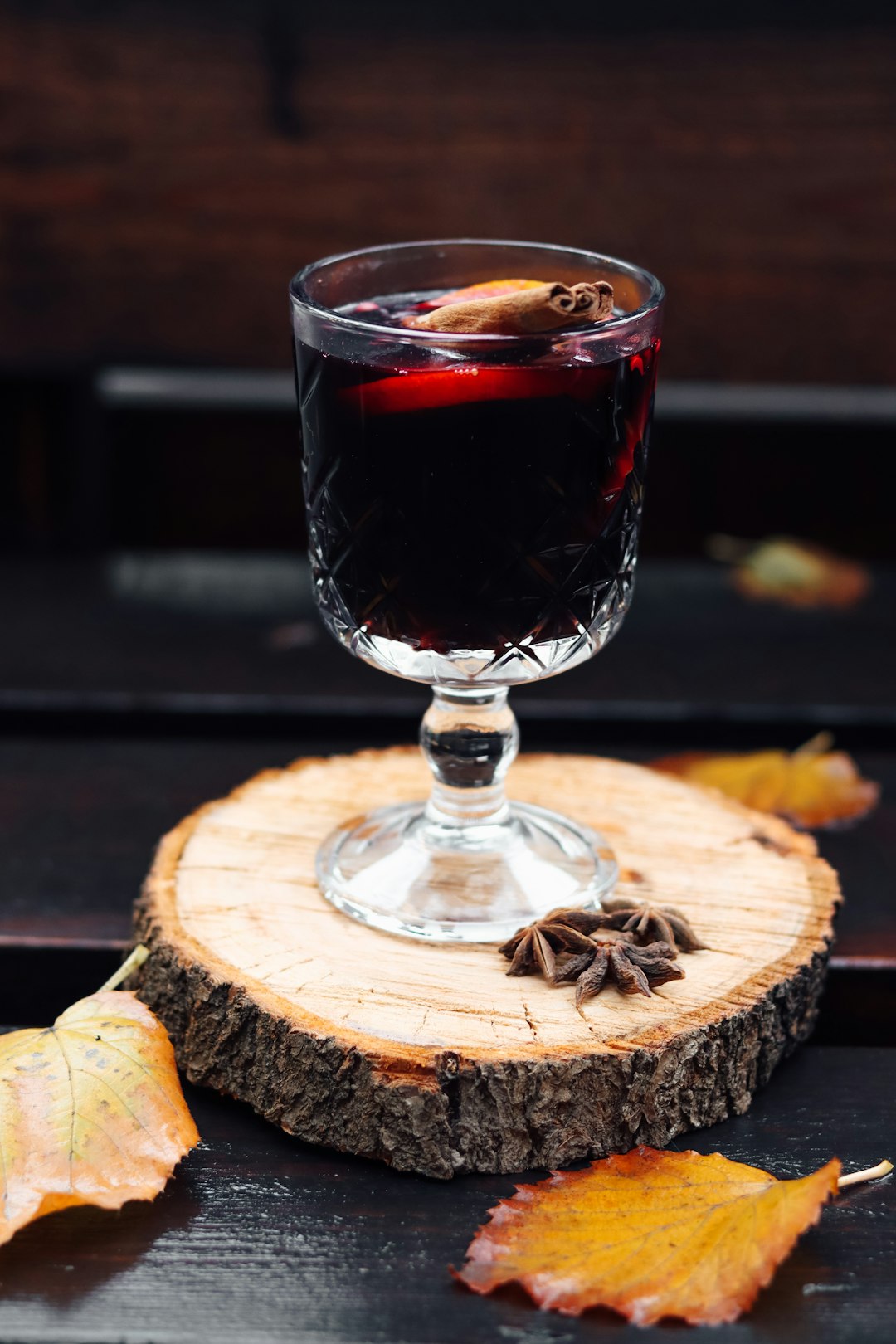 clear wine glass with red wine on brown wooden table