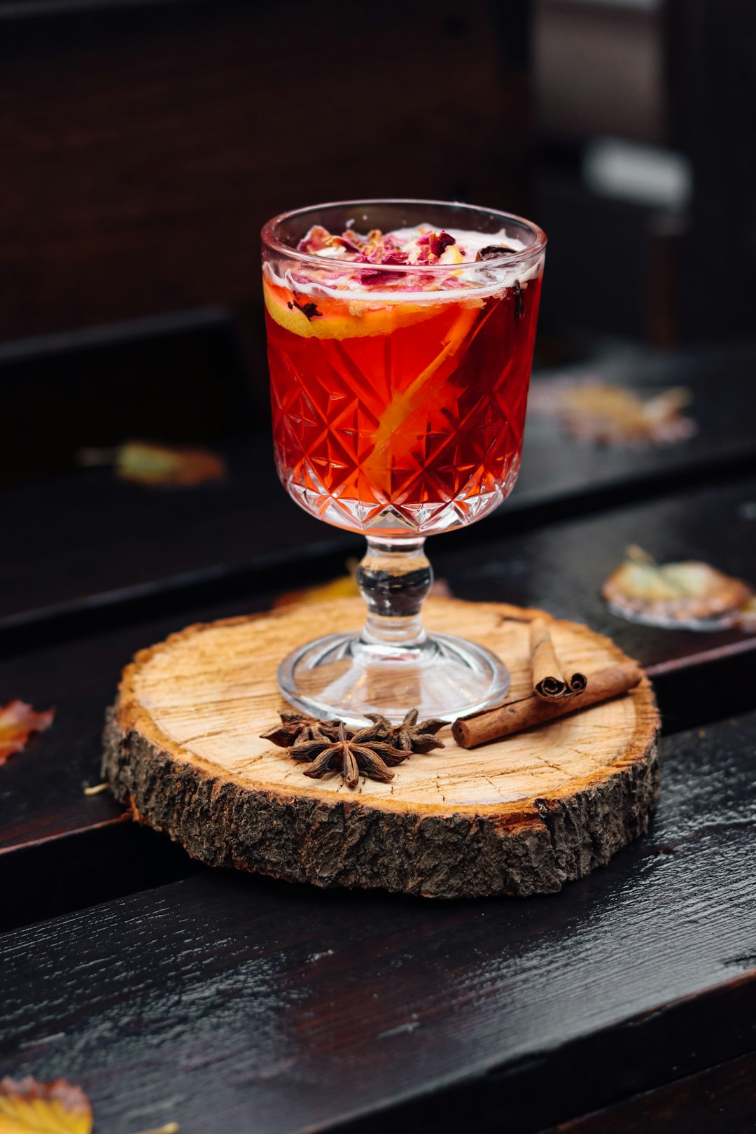 clear glass cup with red liquid on brown wooden coaster