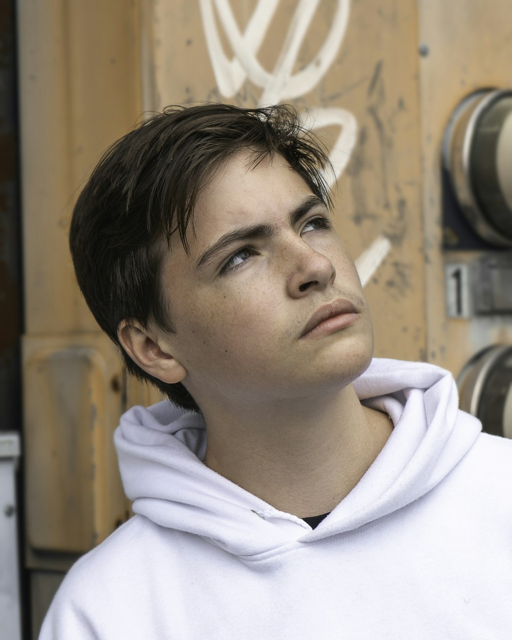 man in white hoodie looking down