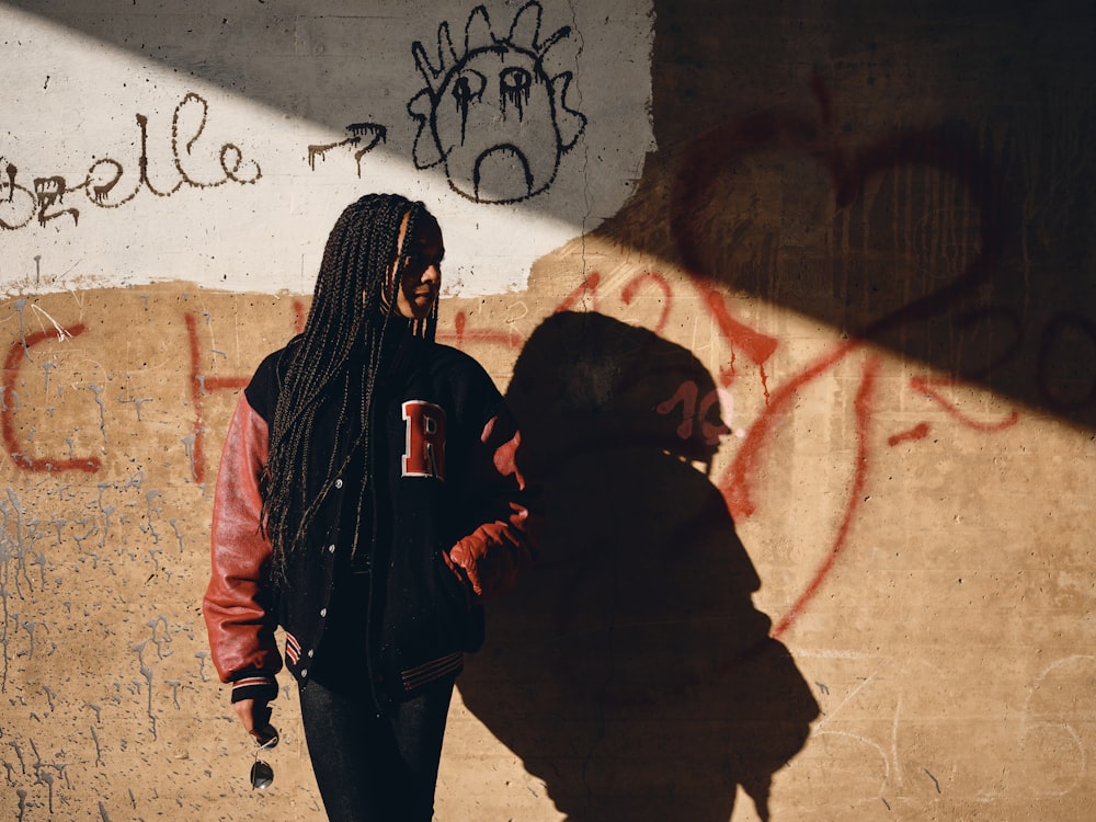 2 person in black hoodie standing beside wall