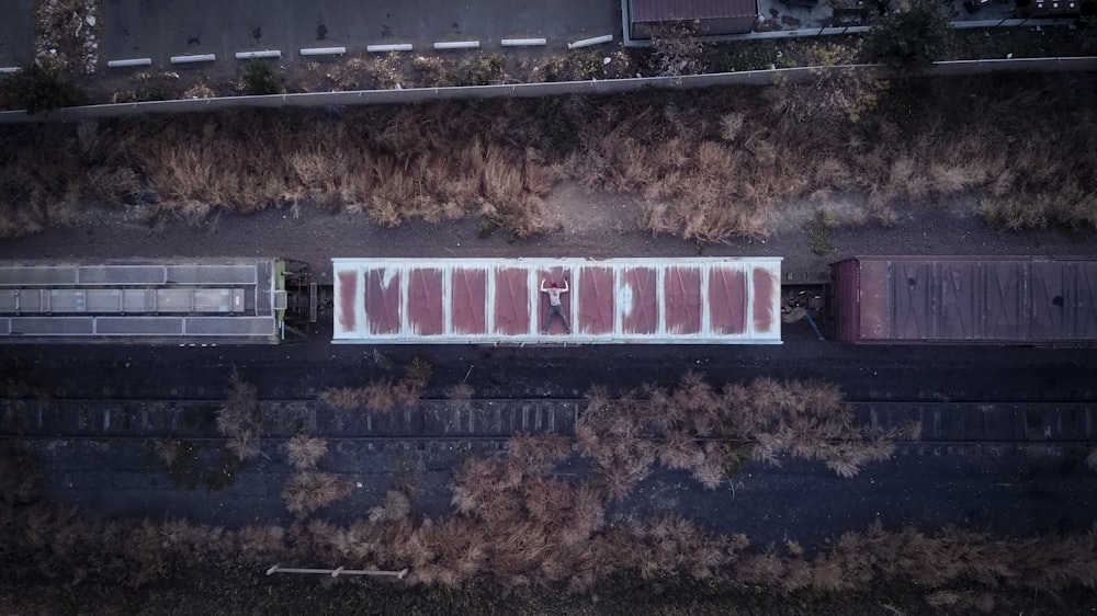 an aerial view of a train yard with a train on the tracks