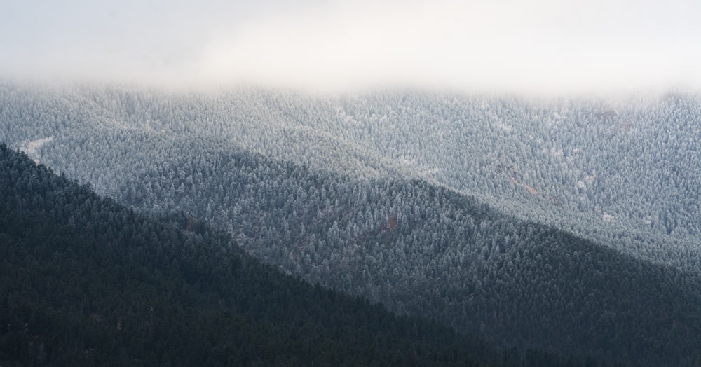 green and white mountain under white clouds