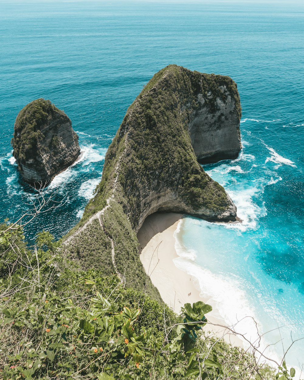 black rock formation on seashore during daytime