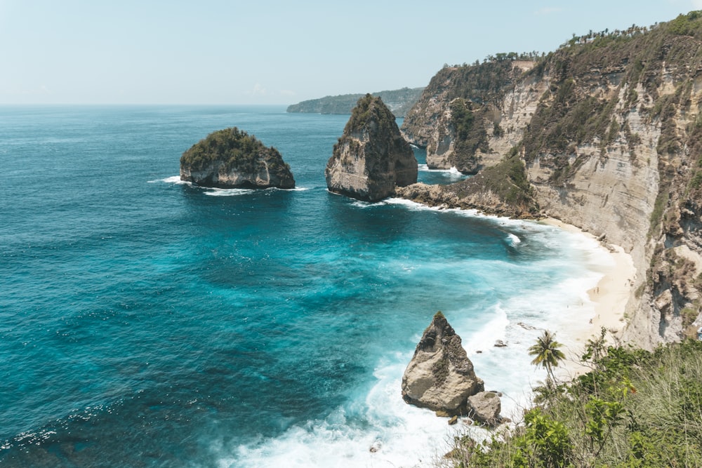 brown rock formation on blue sea water during daytime