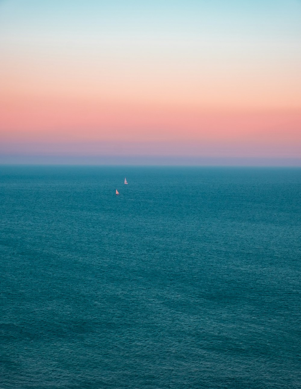 person in the middle of ocean during sunset