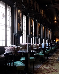 An elegant private dining setup in a dimly lit villa with candles and plush seating.