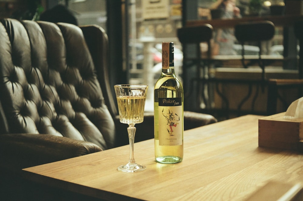 clear glass bottle on brown wooden table