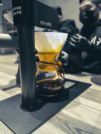 A sleek robotic brewing system in action, showcasing advanced technology.