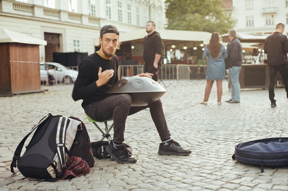 man in black long sleeve shirt sitting on chair