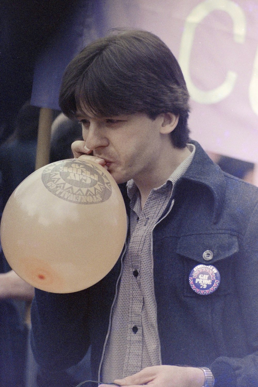 man in black button up shirt holding yellow balloon