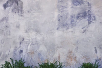 Detail of a green forest-inspired wall texture with gold and blue highlights.