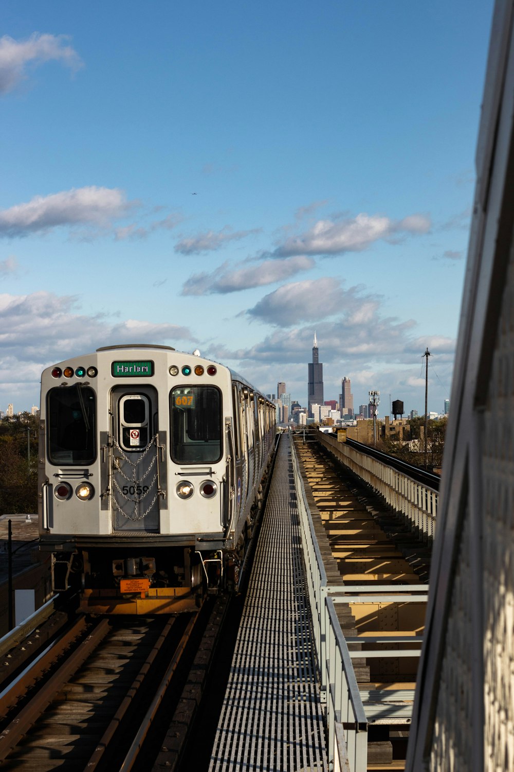 white and black train on rail during daytime