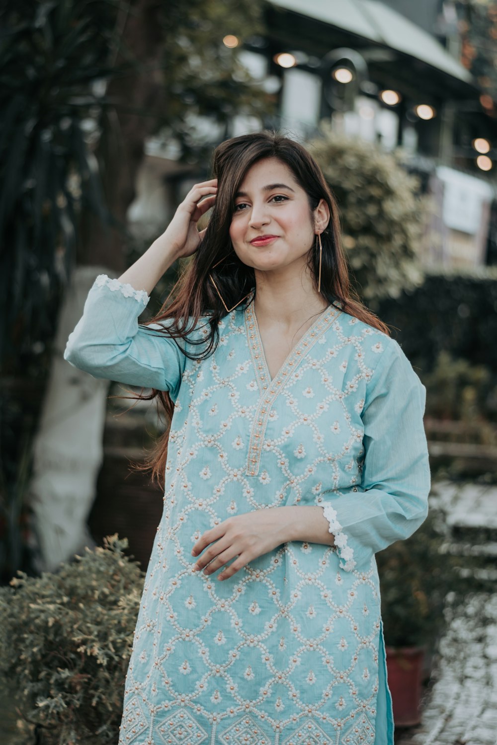 woman in white and blue floral dress