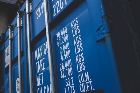 Close-up of a securely loaded cargo container being inspected by a worker.