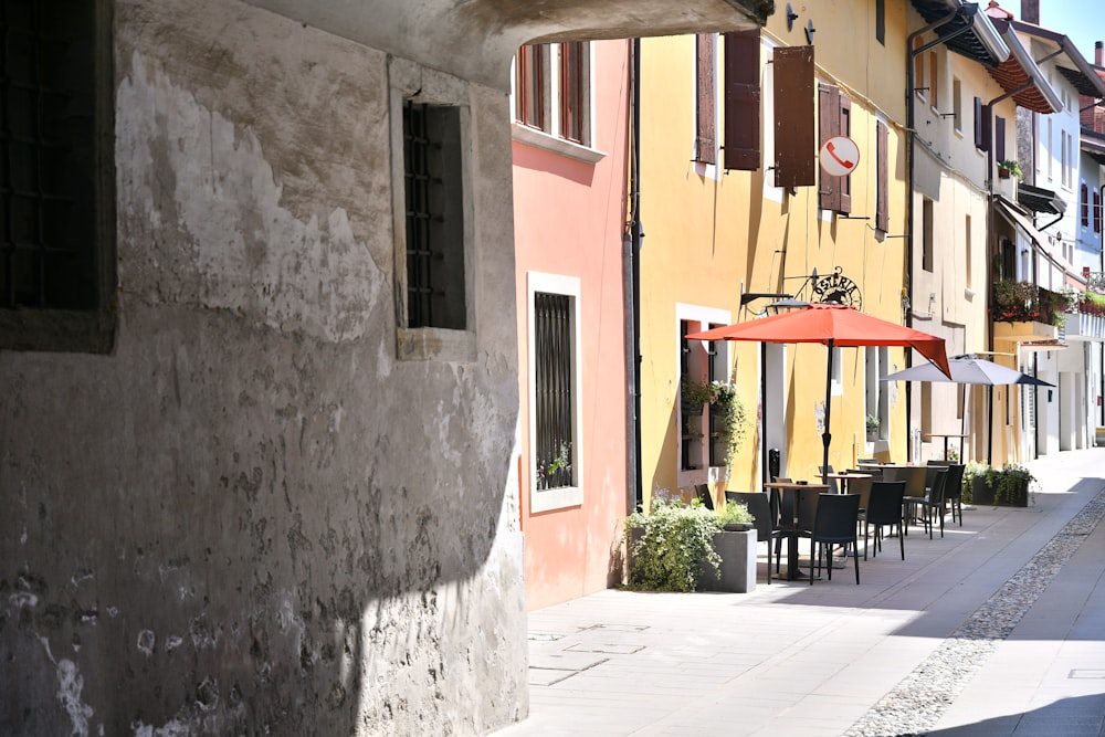 black wooden chairs and tables near gray concrete building during daytime