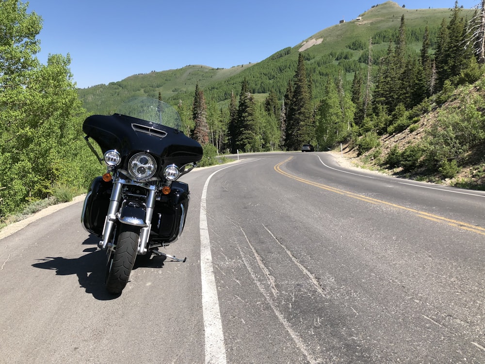 black motorcycle on road during daytime