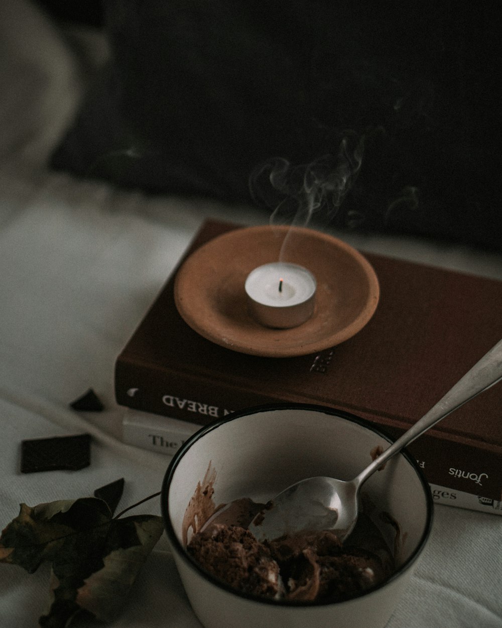 white ceramic bowl with stainless steel spoon