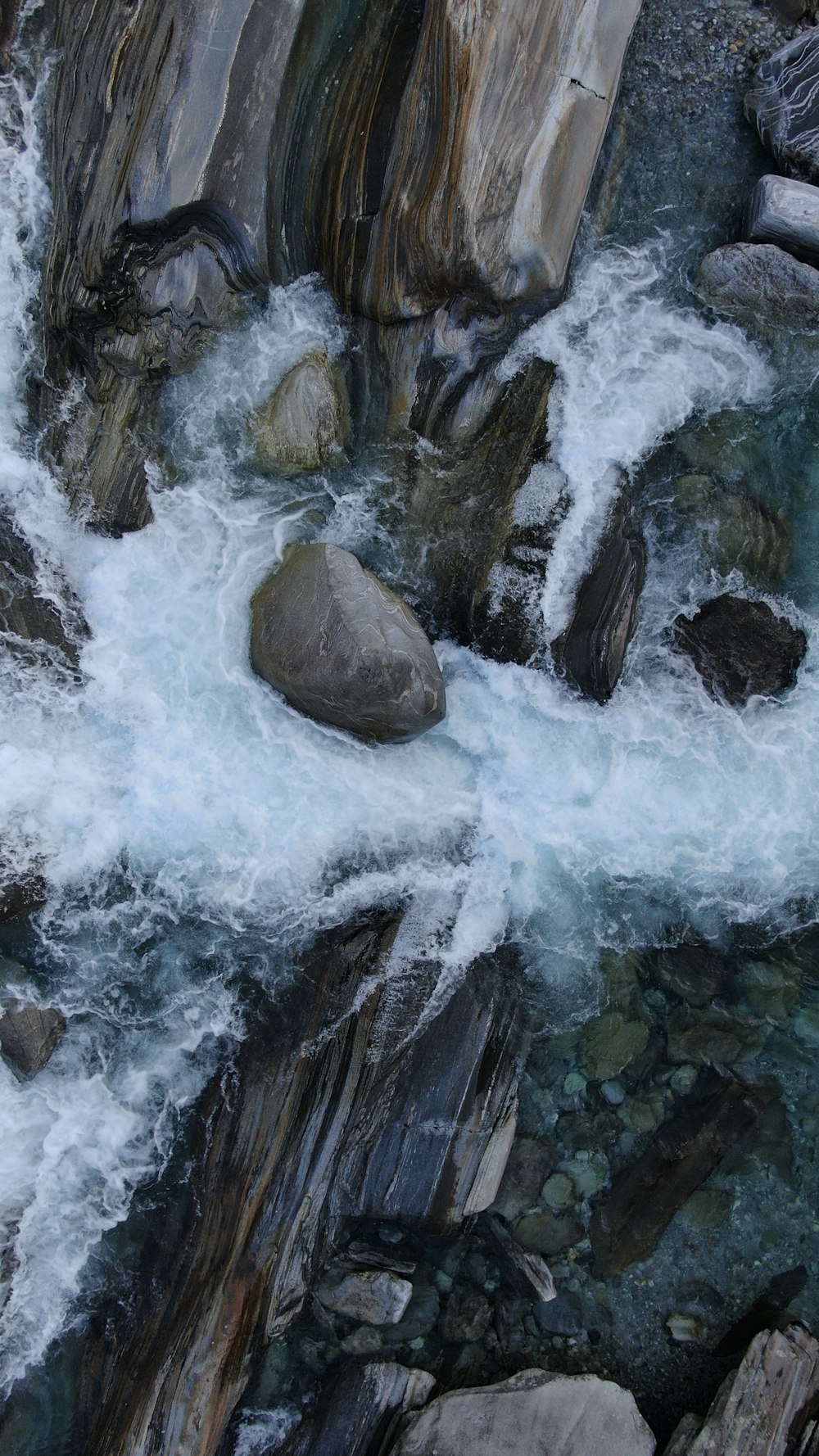 water falls in the middle of rocky mountains