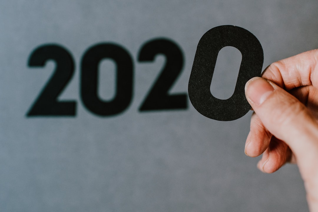 person holding black and white 10 print, 2020 Numbers