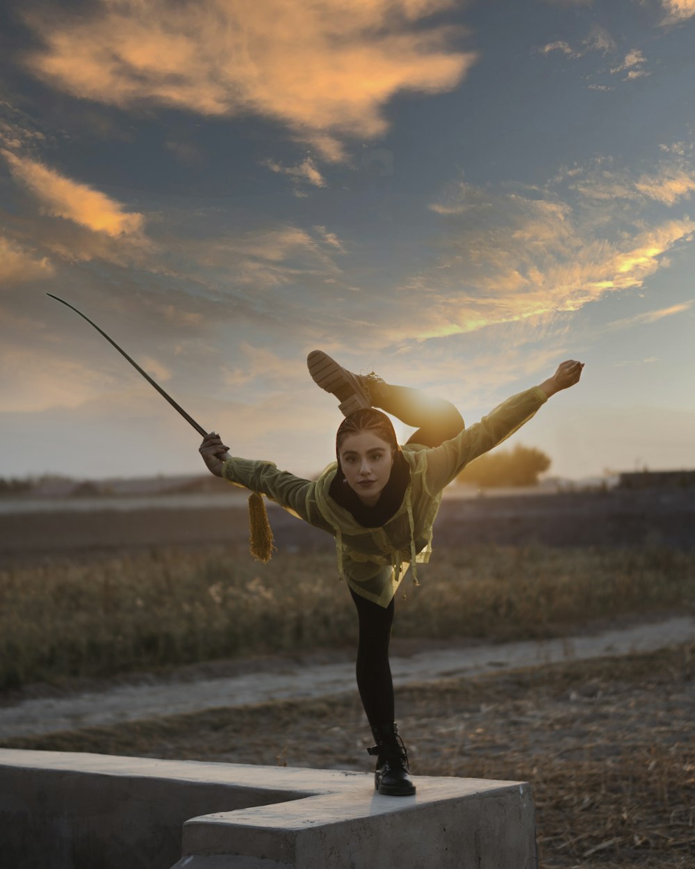 girl in green shirt and black pants running on the beach during daytime