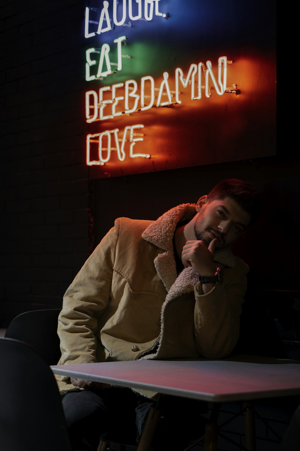 man in white suit jacket sitting on chair