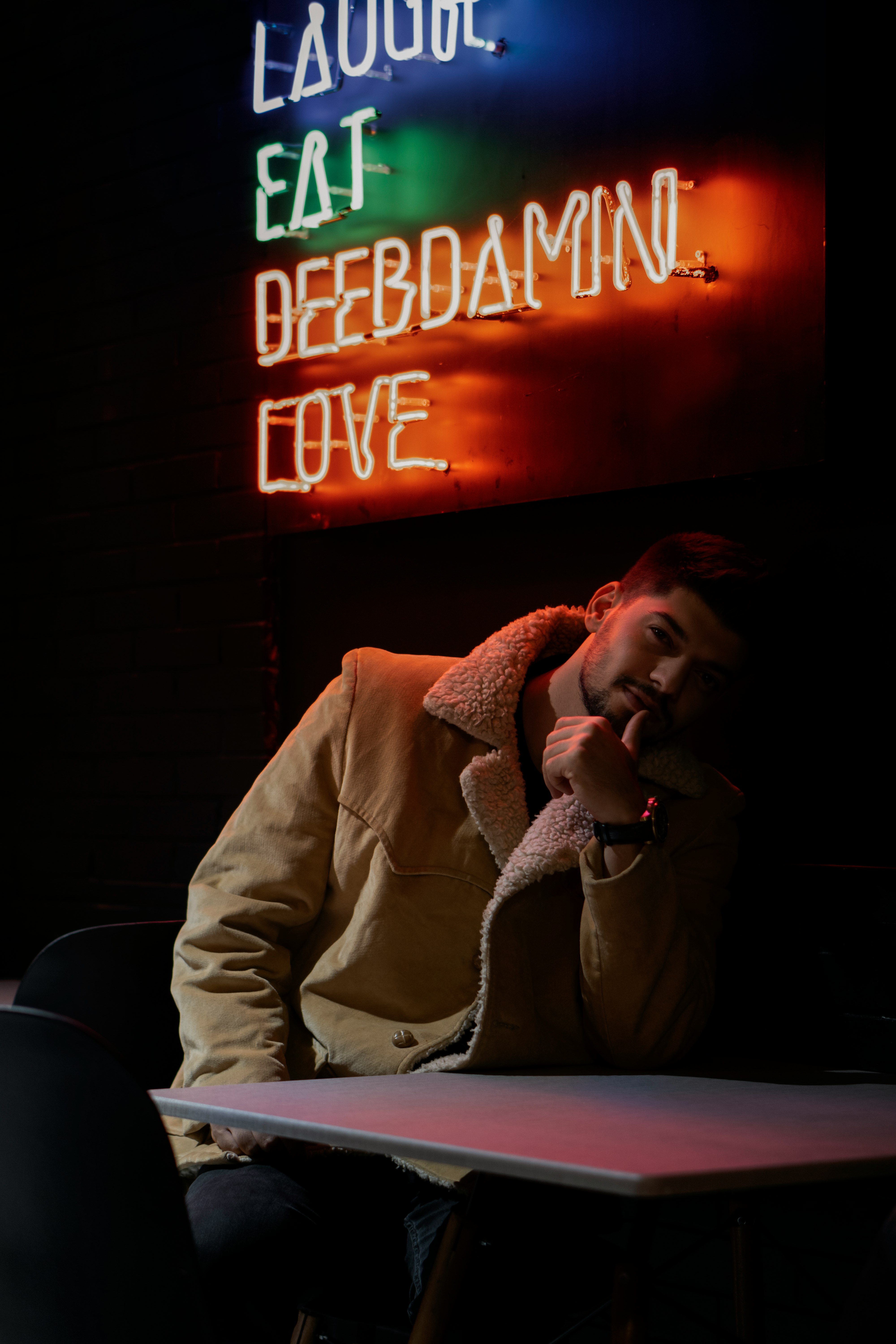 man in white suit jacket sitting on chair