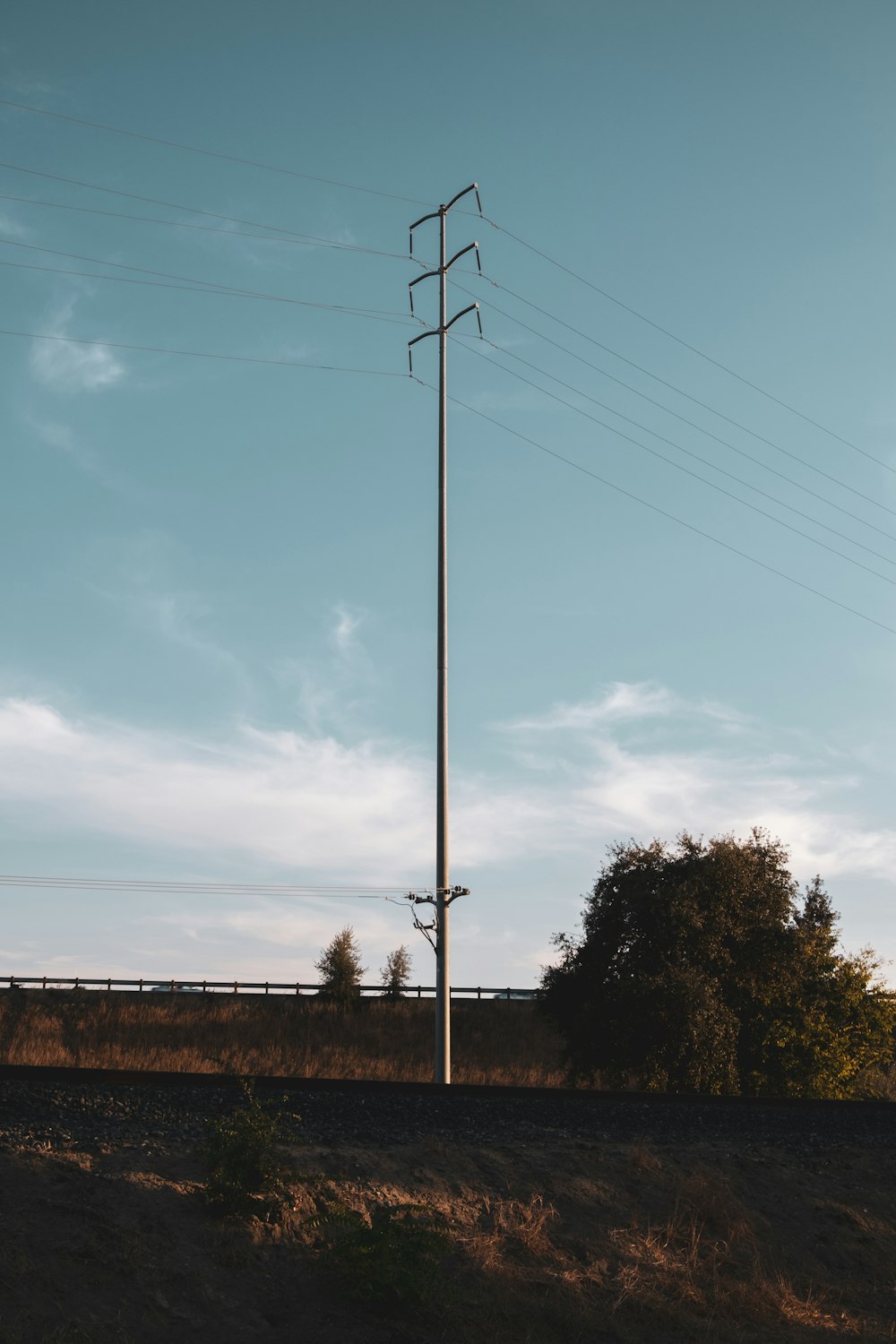 a telephone pole on the side of a road