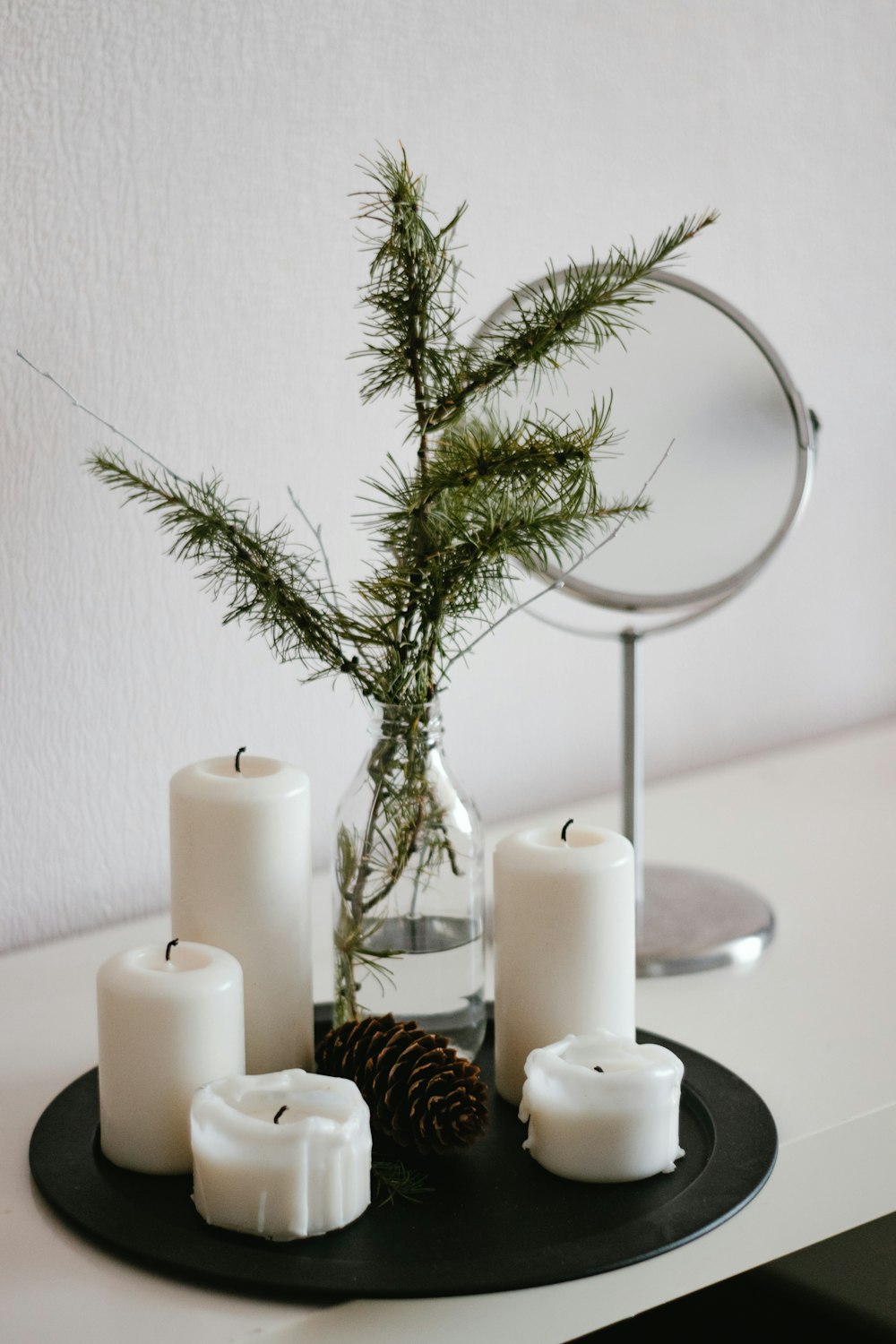 white pillar candles on silver holder